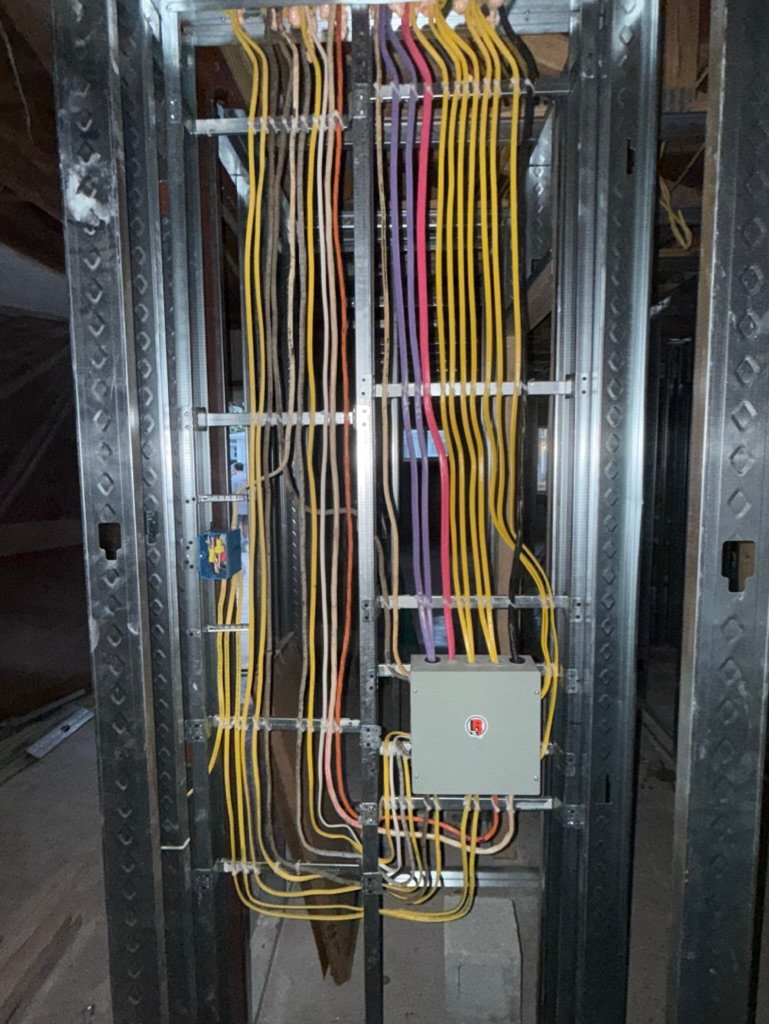 Electrical wiring routed through metal framing during a commercial fit-out
